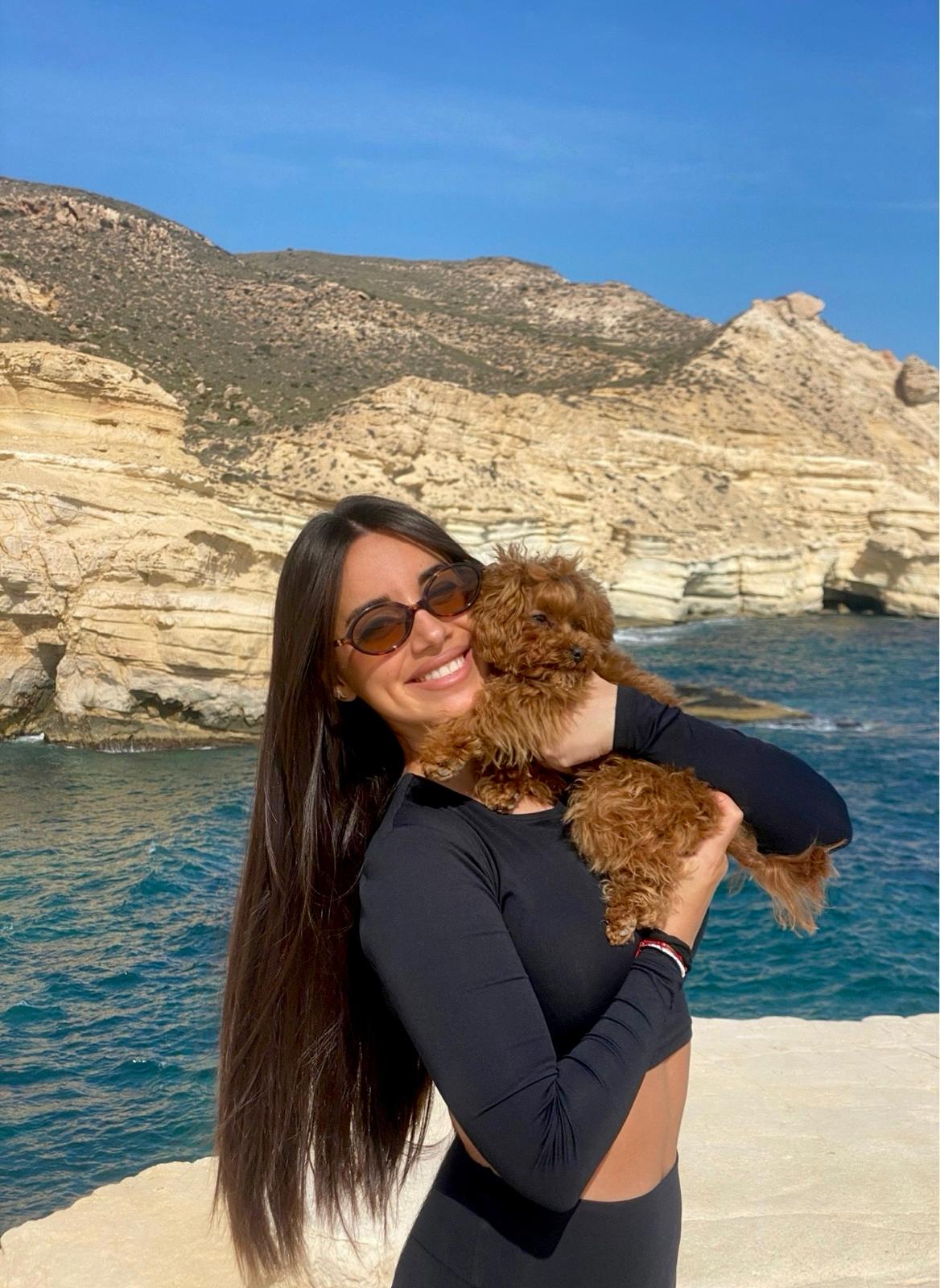 A happy family holding their new puppy.