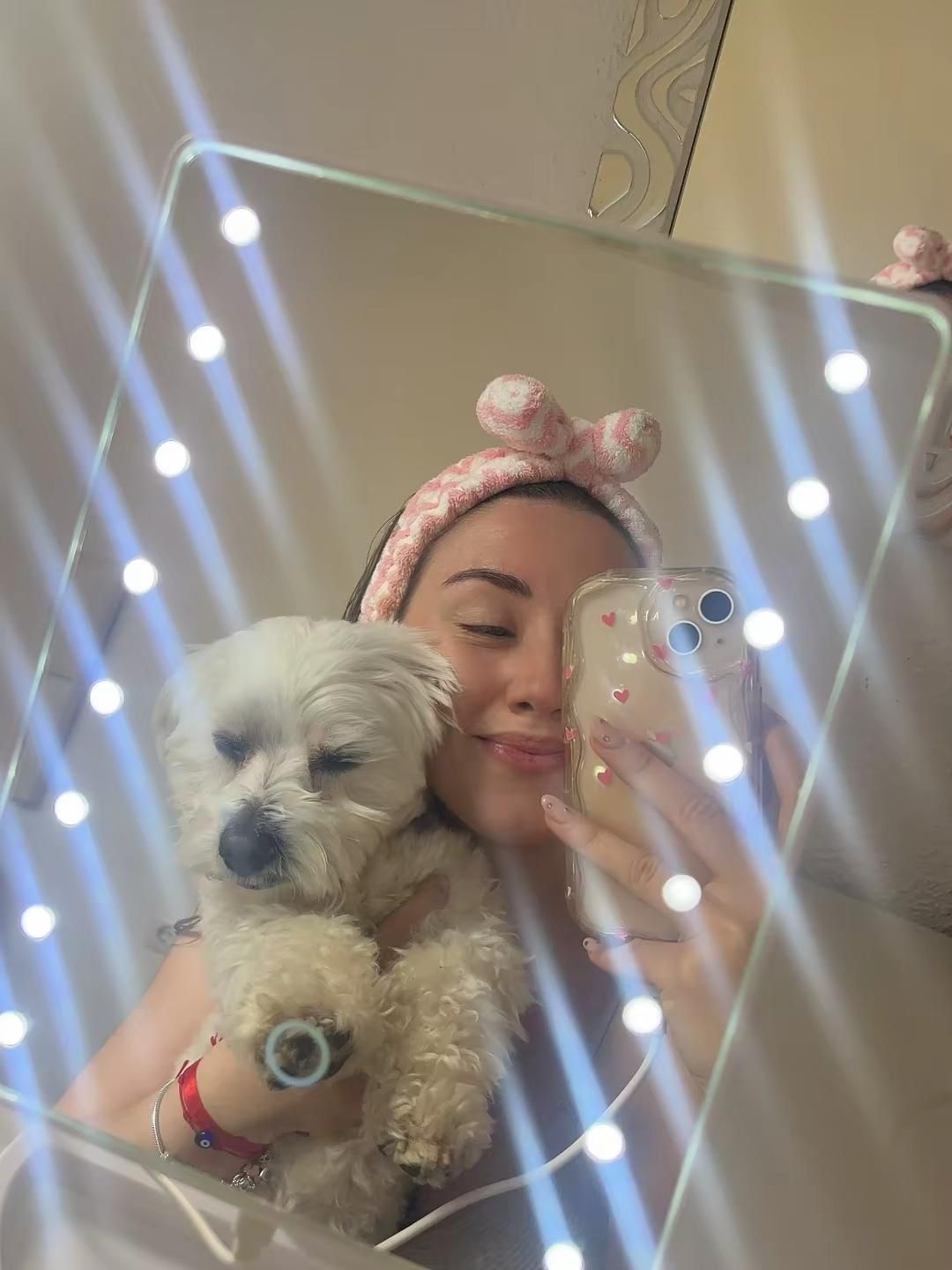 A child hugging a fluffy puppy.