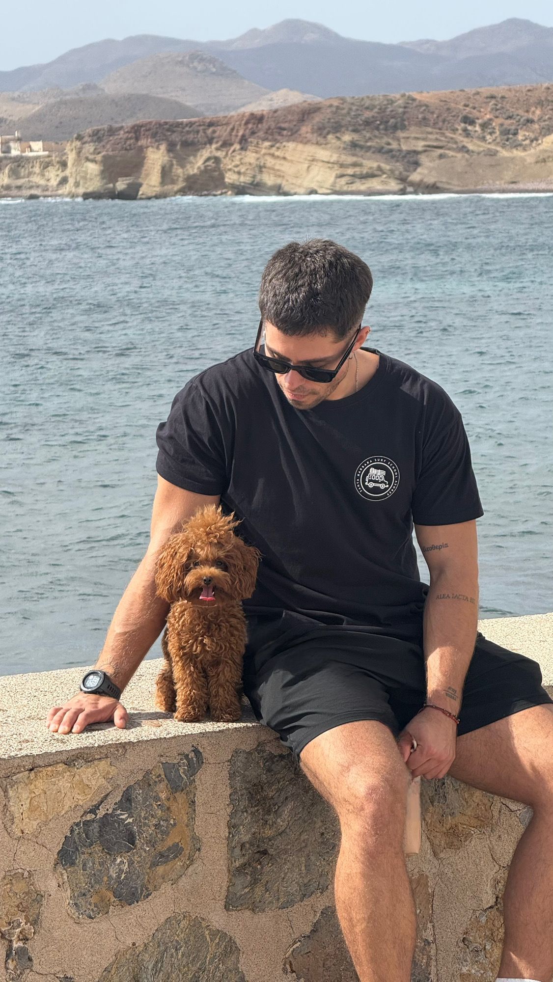 A cute puppy sitting on a lap.